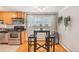 Bright kitchen area with stainless steel appliances, black countertops, and a charming breakfast nook at 1151 N Marion St # 104, Denver, CO 80218