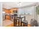 Eat-in kitchen area with stainless steel appliances, tiled floors, and a well-lit breakfast nook at 1151 N Marion St # 104, Denver, CO 80218