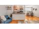 Comfortable living space featuring hardwood floors, a stylish breakfast bar, and contemporary decor at 1151 N Marion St # 104, Denver, CO 80218