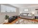 Bright living room featuring a comfortable sofa, modern decor, and hardwood floors with lots of natural light at 1151 N Marion St # 104, Denver, CO 80218