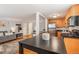 Open-concept living area flowing into a modern kitchen with stainless steel appliances and a breakfast bar at 1151 N Marion St # 104, Denver, CO 80218
