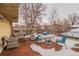 Outdoor seating and a view of nearby buildings and landscape from rooftop deck on a partially snow covered winter day at 1151 N Marion St # 104, Denver, CO 80218