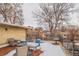 Rooftop deck area with outdoor seating and a view of nearby buildings and landscape on a winter day at 1151 N Marion St # 104, Denver, CO 80218