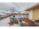 Deck area with outdoor furniture and view of nearby buildings on a winter day with a partially snow-covered surface at 1151 N Marion St # 104, Denver, CO 80218