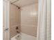 Clean and well-maintained shower and tub featuring neutral-colored tiling and a shower curtain at 1151 N Marion St # 104, Denver, CO 80218