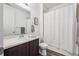 Clean bathroom with white shower curtain, sleek countertop, and wood-look flooring at 95 S Edge Cliff St, Castle Rock, CO 80104