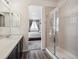 Bathroom with tiled shower, wood-look flooring, and views into the bedroom at 95 S Edge Cliff St, Castle Rock, CO 80104