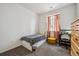 Small bedroom with a cozy bed, accent furniture, and a window with natural light at 95 S Edge Cliff St, Castle Rock, CO 80104