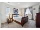 Bright bedroom with a classic wooden bed frame, soft carpet, and a scenic window view at 95 S Edge Cliff St, Castle Rock, CO 80104