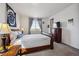 Light-filled bedroom with stylish curtains, a wooden dresser, and exterior views at 95 S Edge Cliff St, Castle Rock, CO 80104
