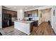 Modern kitchen with stainless steel appliances, dark wood cabinets, and a central island at 95 S Edge Cliff St, Castle Rock, CO 80104
