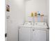 Bright laundry room features white washer and dryer with storage shelf above at 95 S Edge Cliff St, Castle Rock, CO 80104