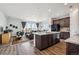 Open-concept living room and kitchen filled with natural light from large windows at 95 S Edge Cliff St, Castle Rock, CO 80104