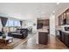 An open-concept living space with a modern kitchen, and living and dining areas at 95 S Edge Cliff St, Castle Rock, CO 80104