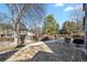 Fenced backyard featuring a mature tree, picnic table and play structure at 3283 W 102Nd Pl, Westminster, CO 80031