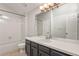 Bright bathroom featuring a tub with tile surround, toilet, and vanity with ample storage at 3283 W 102Nd Pl, Westminster, CO 80031