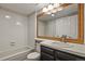 Bathroom featuring a shower over the tub, large mirror and vanity at 3283 W 102Nd Pl, Westminster, CO 80031