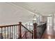 Second floor hall featuring hardwood floors, decorative lighting, stair railings and a view of the front door below at 3283 W 102Nd Pl, Westminster, CO 80031