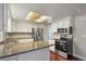 Well lit kitchen with white cabinets, stainless steel appliances and granite counter tops at 3283 W 102Nd Pl, Westminster, CO 80031