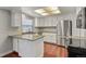 Bright kitchen featuring white cabinets, stainless steel refrigerator, and granite countertops at 3283 W 102Nd Pl, Westminster, CO 80031