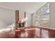 Living room with a brick fireplace, large windows, and hardwood floors at 3283 W 102Nd Pl, Westminster, CO 80031