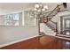 Spacious living room with hardwood floors, staircase, and view of the entryway at 3283 W 102Nd Pl, Westminster, CO 80031