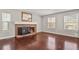 Spacious living room with fireplace, hardwood floors and lots of natural light from the windows at 3283 W 102Nd Pl, Westminster, CO 80031