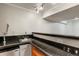 Wet bar featuring sink, faucet, dark countertop, stainless fridge and beer tap at 3283 W 102Nd Pl, Westminster, CO 80031