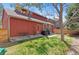 Spacious backyard with lush grass, concrete patio, grill, and table at 944 E Lily Ct, Highlands Ranch, CO 80126