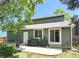 Backyard patio with grill, green siding and mature trees for outdoor enjoyment at 944 E Lily Ct, Highlands Ranch, CO 80126
