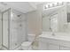 Bright bathroom featuring glass enclosed shower, tiled floors, vanity, and modern fixtures at 944 E Lily Ct, Highlands Ranch, CO 80126