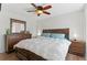 Cozy bedroom featuring a bed with blue pillows, matching nightstands, and a dresser creating a relaxing retreat at 944 E Lily Ct, Highlands Ranch, CO 80126