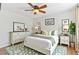 Cozy bedroom with a floral rug, ceiling fan, and a beautifully decorated dresser at 944 E Lily Ct, Highlands Ranch, CO 80126