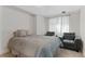 Cozy bedroom with comfortable seating, soft carpet, and sheer curtains at 944 E Lily Ct, Highlands Ranch, CO 80126