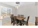 Bright dining room featuring a wooden table, six chairs, and a large window, offering an inviting atmosphere at 944 E Lily Ct, Highlands Ranch, CO 80126