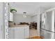 Open plan dining with stainless steel refrigerator, wooden table, six chairs, offering a relaxing atmosphere at 944 E Lily Ct, Highlands Ranch, CO 80126