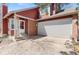 Charming two-story home with brick accents, manicured lawn, and attached two-car garage at 944 E Lily Ct, Highlands Ranch, CO 80126