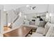 Bright living room featuring a fireplace, high ceilings, natural light, staircase and large sectional sofa at 944 E Lily Ct, Highlands Ranch, CO 80126