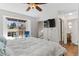 Bright main bedroom featuring large windows, wood flooring and convenient ensuite bathroom at 944 E Lily Ct, Highlands Ranch, CO 80126