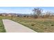 Neighborhood walking path offers views of open space, playground, and the front range at 944 E Lily Ct, Highlands Ranch, CO 80126