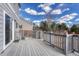 Wide wooden back deck with gray railings, providing ample outdoor space for leisure and gatherings at 18668 E Vassar Dr, Aurora, CO 80013