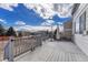 Spacious back deck with wooden planks and railings, offering outdoor relaxation and entertaining space at 18668 E Vassar Dr, Aurora, CO 80013
