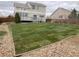 Landscaped backyard with new sod and wooden fence, providing a private and green outdoor area at 18668 E Vassar Dr, Aurora, CO 80013