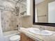 Full bathroom with shower over tub combination, light wood vanity and backsplash with large mirror at 18668 E Vassar Dr, Aurora, CO 80013