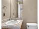 Neutral half bathroom featuring a single sink, vanity, mirror and toilet at 18668 E Vassar Dr, Aurora, CO 80013