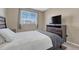 Bedroom with a window and sleek furniture set at 18668 E Vassar Dr, Aurora, CO 80013