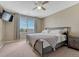 Bedroom features a ceiling fan, window with blinds, and a comfortable bed at 18668 E Vassar Dr, Aurora, CO 80013