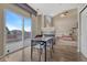 Sunlit dining area showcasing outdoor access, fireplace, and the living room at 18668 E Vassar Dr, Aurora, CO 80013