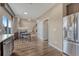 Spacious dining area featuring wood floors and seamless transition to kitchen and living room at 18668 E Vassar Dr, Aurora, CO 80013
