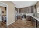 Modern kitchen with stainless steel appliances, tile backsplash, wood flooring, and abundant cabinet space at 18668 E Vassar Dr, Aurora, CO 80013